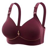 Maroon bra with decorative heart charm on a white background