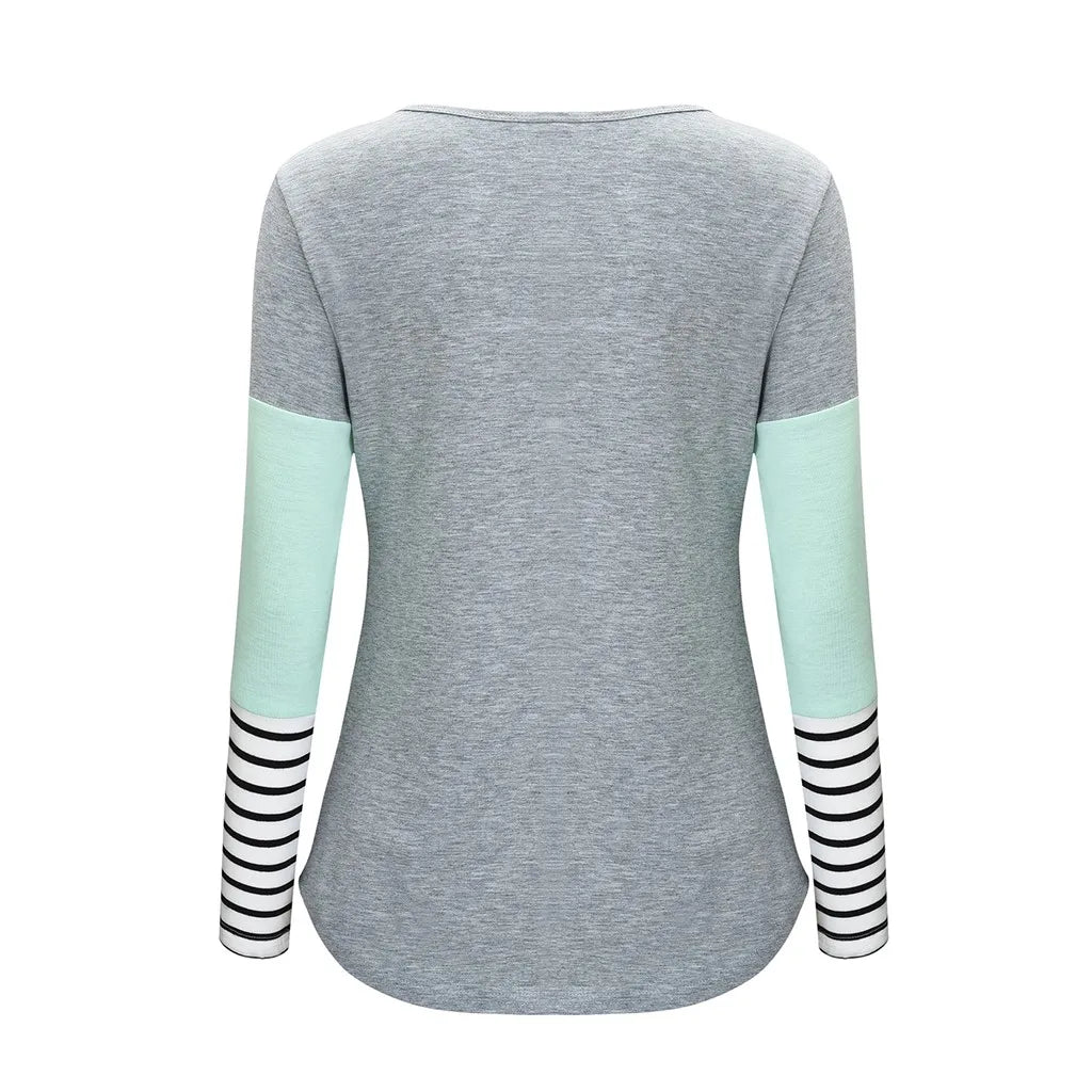 Gray long-sleeve shirt with light green sleeves and black and white striped cuffs on a white background