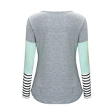 Gray long-sleeve shirt with light green sleeves and black and white striped cuffs on a white background