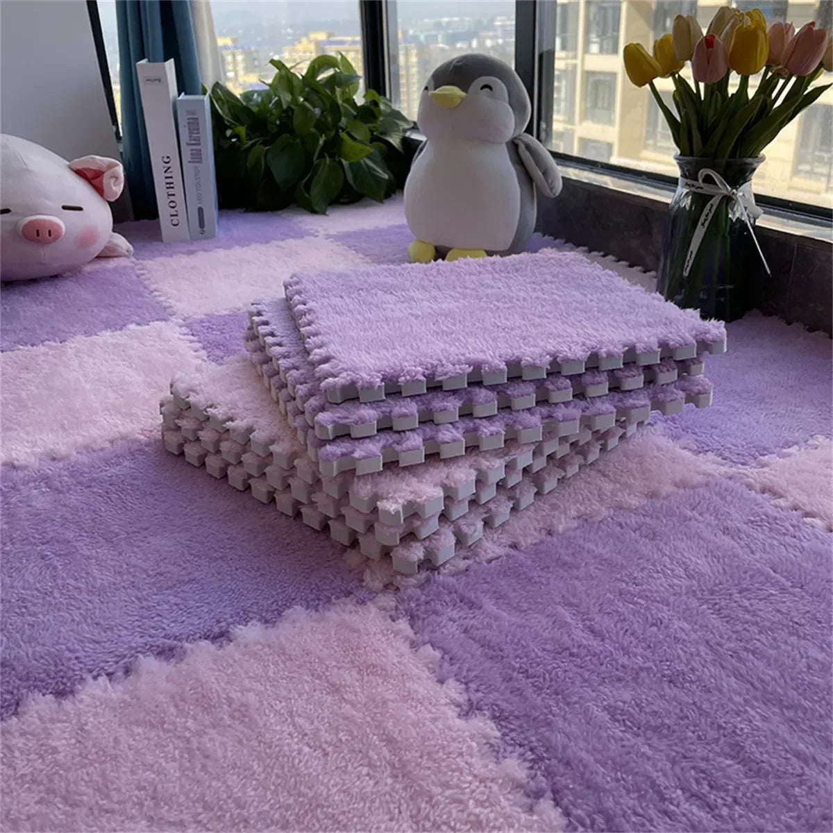 Purple interlocking foam mats on a checkered floor with a penguin toy and flowers in the background.