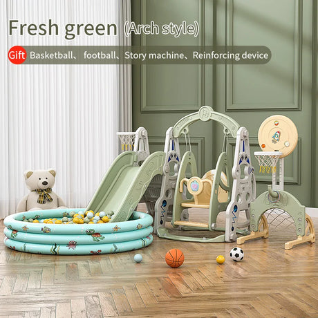 Children's play area with green arch-style playset, slide, and toys on a wooden floor.