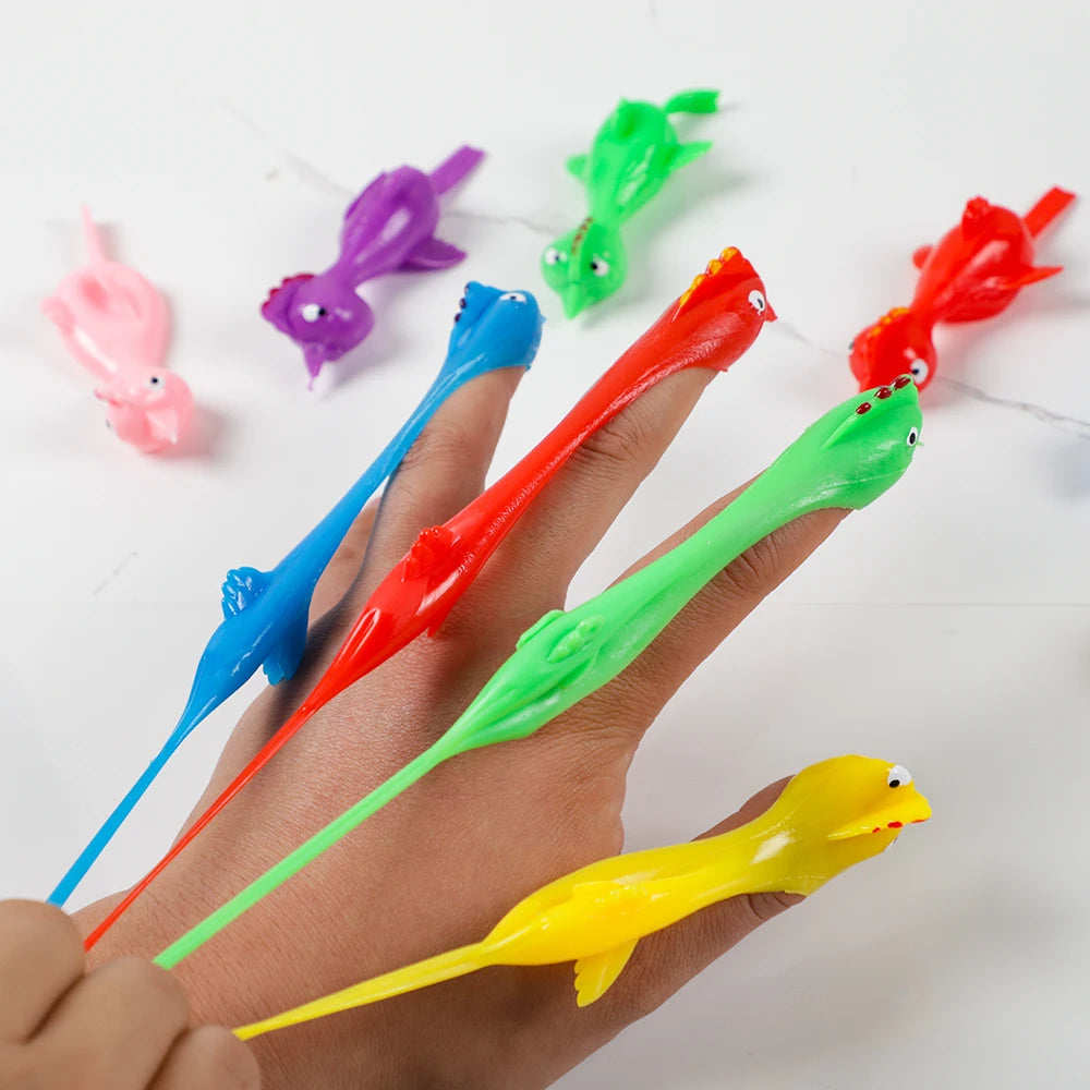 Colorful plastic toys shaped like fish on a hand with a white background