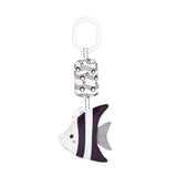 Black and white striped fish-shaped keychain with a patterned tag on a white background