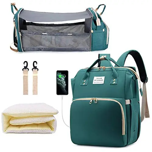 Collection of baby care products including a teal backpack, crib, and accessories on a white background.