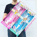 Two toy microphone sets in pink and blue packaging held by a person against a light gray background.