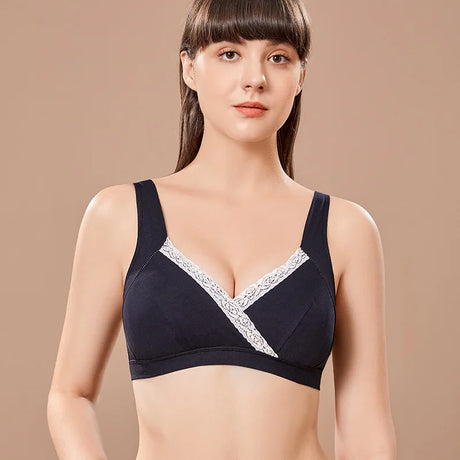 Woman wearing a black bra with lace trim on a beige background