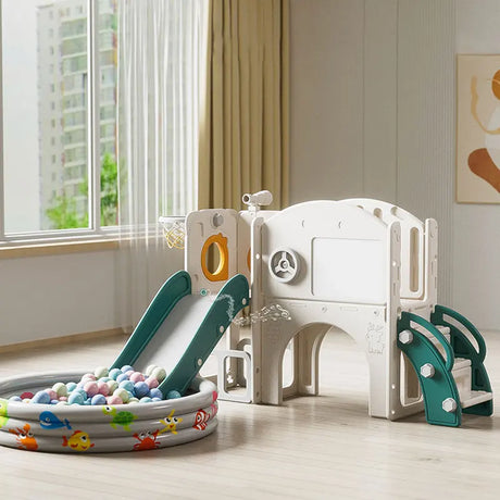 Children's playset with slide and ball pit in a room with a window.