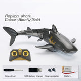 Replica shark toy with remote control, screwdriver, USB charger, spare propeller, and battery.