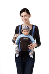 A woman holding a baby in a carrier.