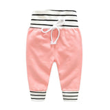 Pink baby pants with black and white striped details 