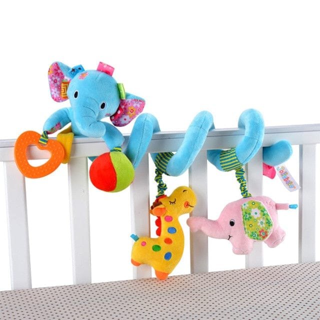 Colorful baby crib mobile with elephant and dinosaur toys on a white crib.