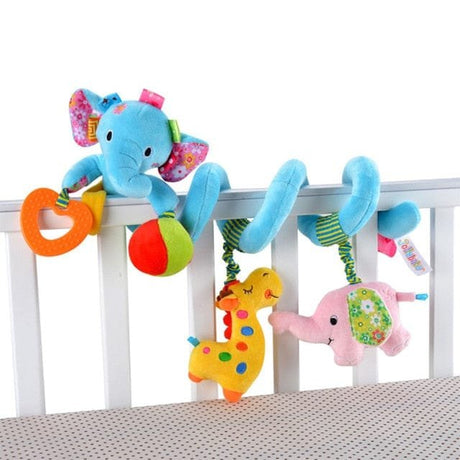 Colorful baby crib mobile with elephant and dinosaur toys on a white crib.
