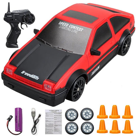 Red and black toy car with remote control, batteries, and cones.