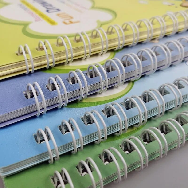 Stack of colorful notebooks with spiral binding on a light gray background