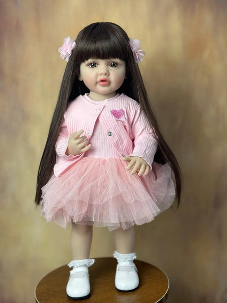 A doll in a pink outfit with a heart design.
