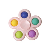 Pink fidget spinner with colorful dots.