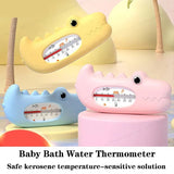 Three colorful shark-shaped baby bath water thermometers on a soft background.