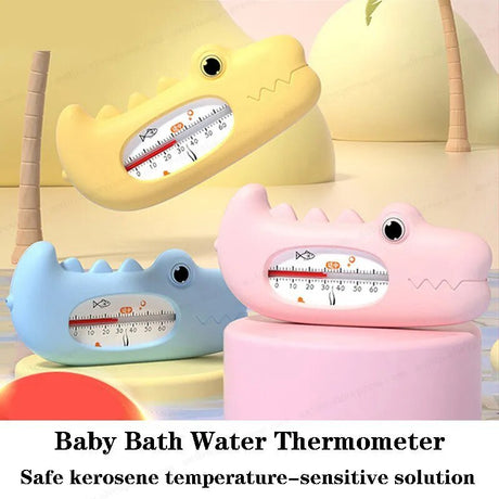 Three colorful shark-shaped baby bath water thermometers on a soft background.