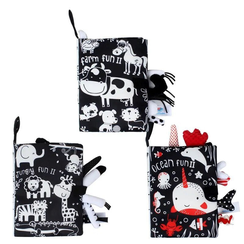 Three soft books with animal-themed designs on a white background