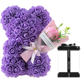 Purple rose teddy bear with a small bouquet of pink roses.