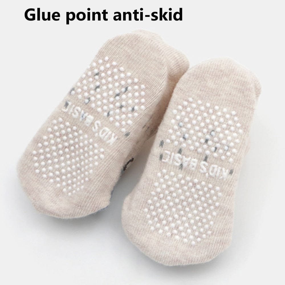 Pair of beige socks with anti-skid dots.
