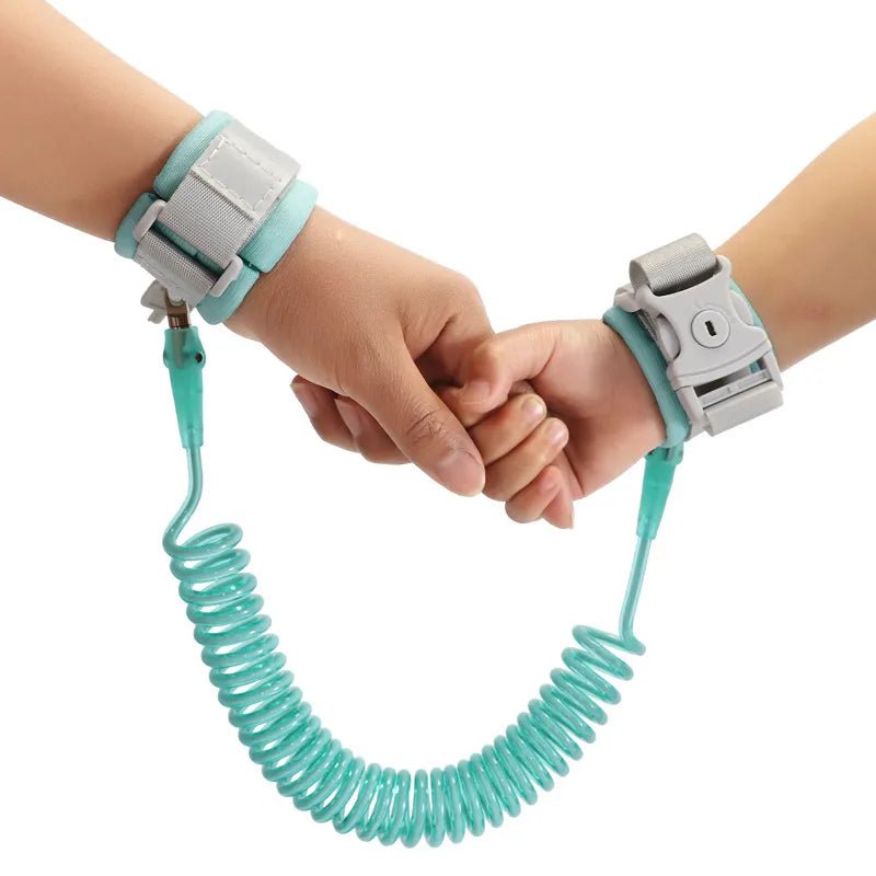 Two hands holding each other with a teal coiled leash.