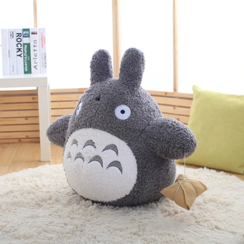 Plush toy resembling a character with large eyes and a small mouth on a soft surface.