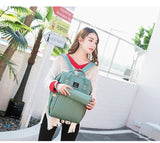 Woman holding a green backpack