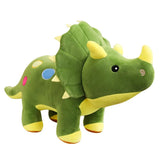 Green plush dinosaur toy with yellow horns on a white background