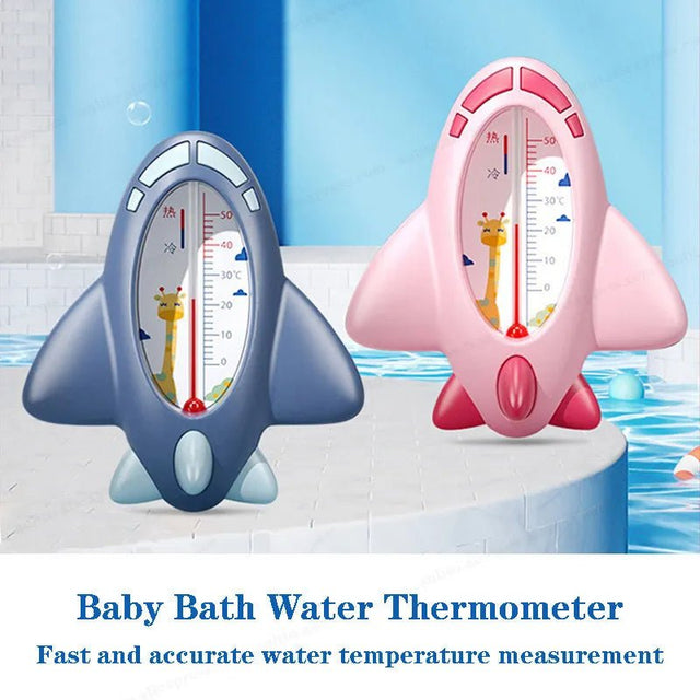 Two baby bath water thermometers, one blue and one pink, with cartoon characters on a bathtub background.