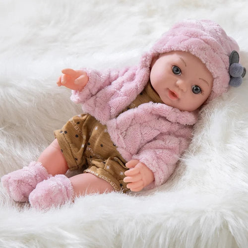 Baby doll in a pink outfit and hat.