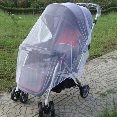 Baby stroller with a transparent mesh cover on a paved path.