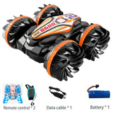 Black and orange remote-controlled vehicle with accessories 