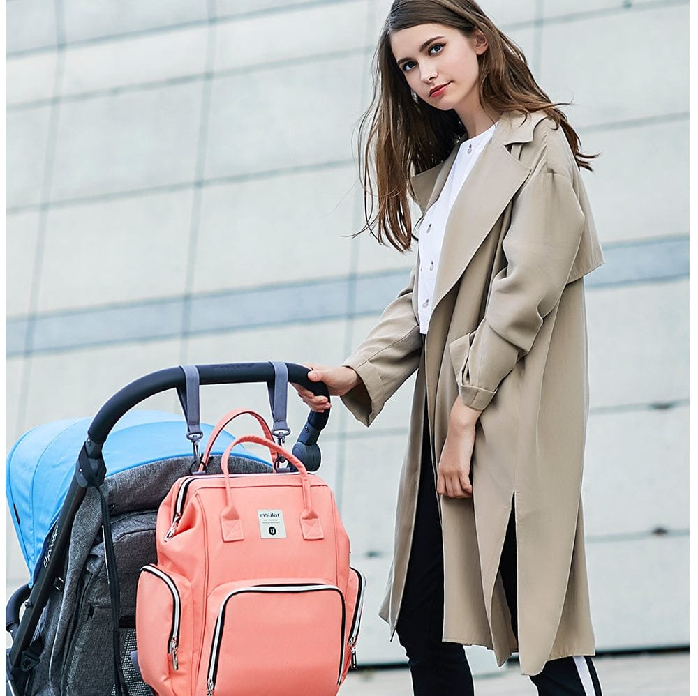 Woman in a beige coat with a pink backpack