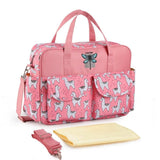 Pink diaper bag with animal print and accessories