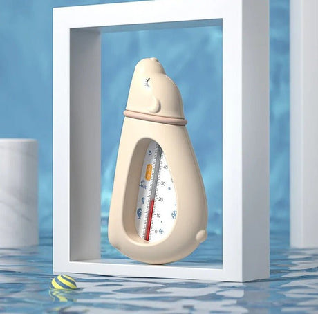 Bottle-shaped thermometer in a white frame with water and pool tiles in the background