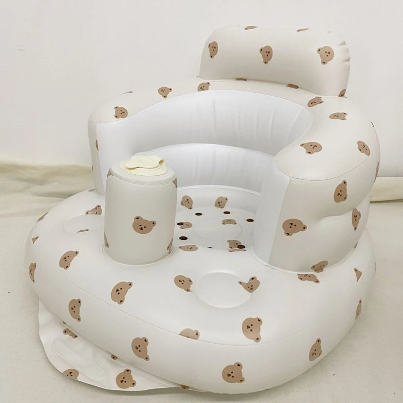 White inflatable baby seat with teddy bear pattern on a white background