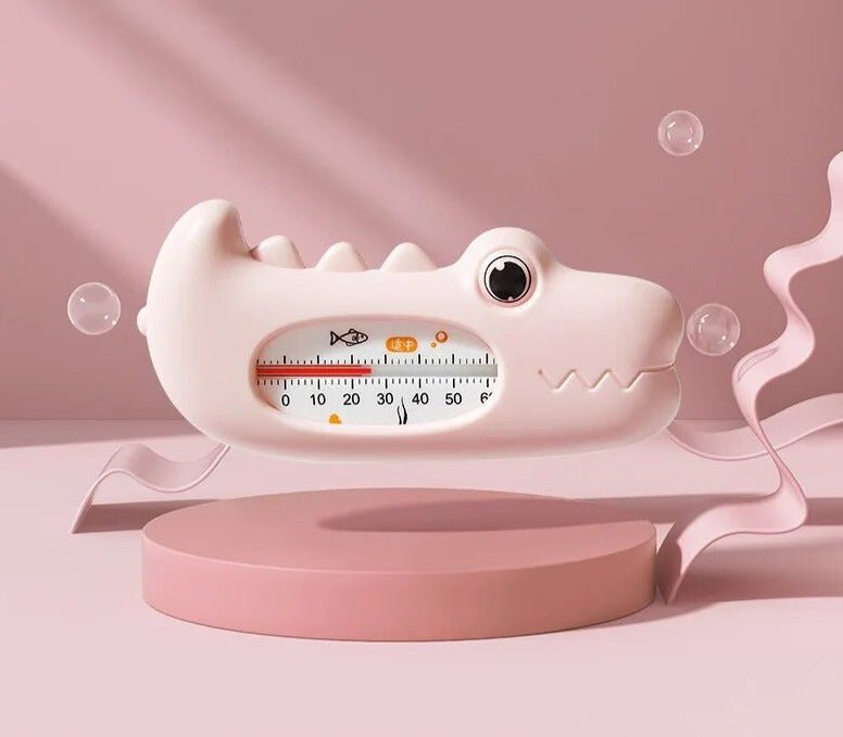 White shark-shaped thermometer on a pink background