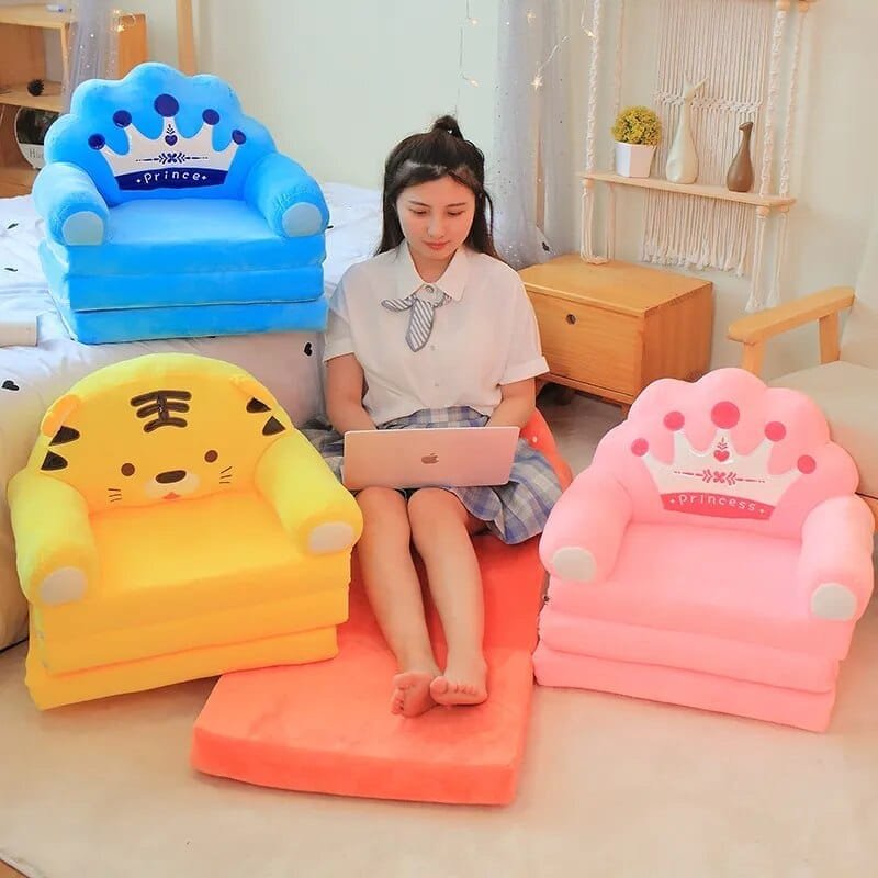 Woman sitting on a colorful inflatable chair with cartoon designs, surrounded by similar chairs in different colors.
