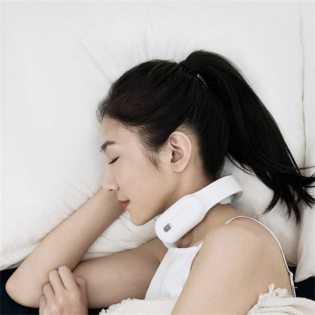 Woman using a neck massager on a white background