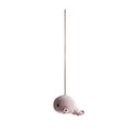 Knitted whale-shaped toy hanging from a string