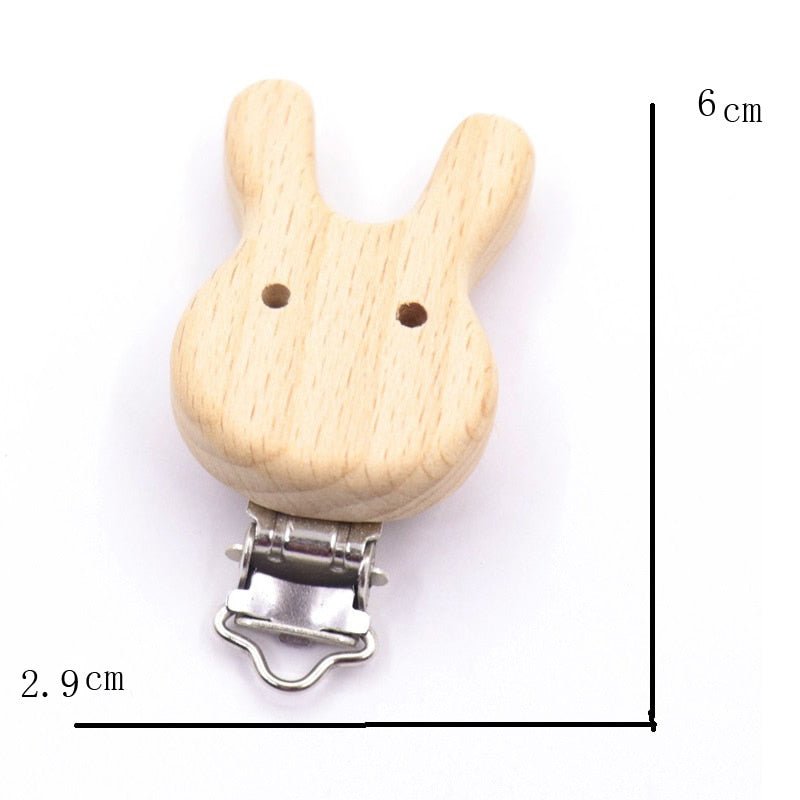 Wooden rabbit-shaped pacifier clip with measurements on a white background
