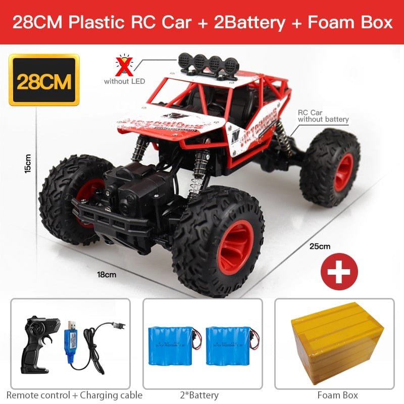Red and black RC car with remote control and batteries.