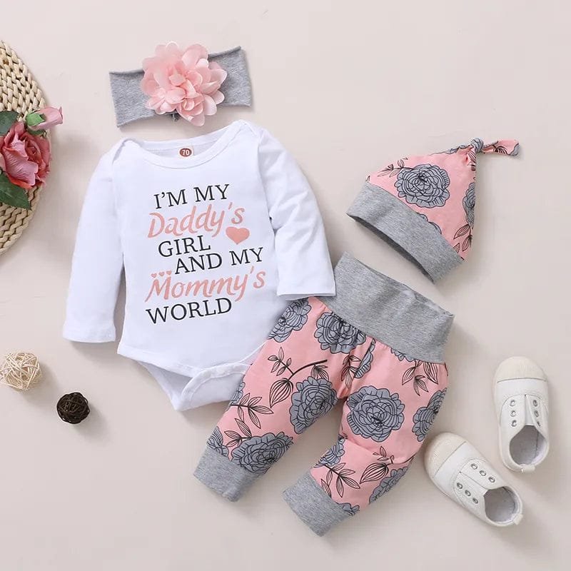 Baby outfit set with floral pants, white shirt, and matching headband on a light background