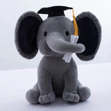 Gray plush elephant toy wearing a graduation cap and tassel on a white background