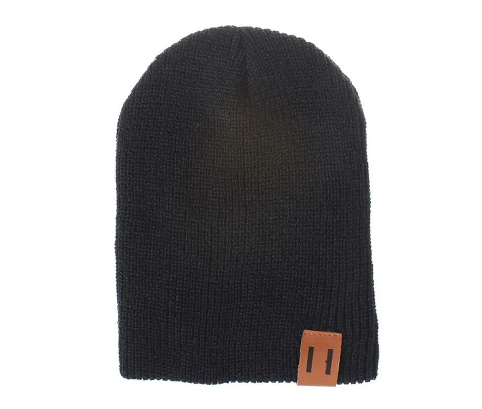 Black knit beanie with a brown leather patch on a white background
