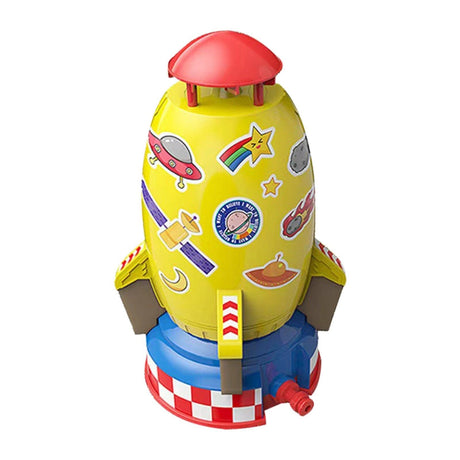 Colorful toy rocket with various stickers on a white background