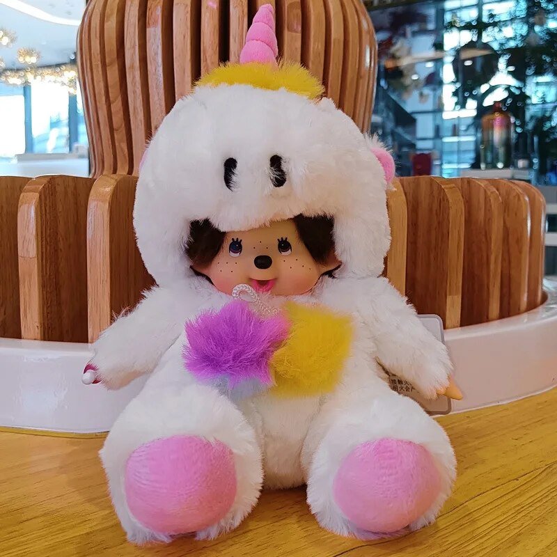 Stuffed toy resembling a character in a unicorn costume with colorful accents on a wooden surface.