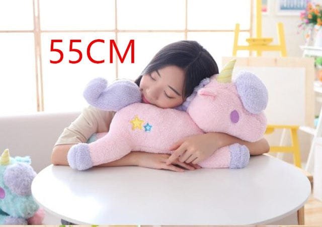 Person holding a large pink and purple plush toy with '55CM' text above, sitting on a white table.