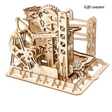 Wooden mechanical model of a lift coaster on a white background